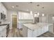 Well-lit open kitchen featuring modern cabinetry, an oversized island and convenient access to the walk-in pantry at 5251 Graystone, Pahrump, NV 89061
