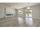 Bright living room area featuring a modern fireplace, stylish chandelier, and convenient sliding door to outside at 5251 Graystone, Pahrump, NV 89061