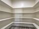 Spacious walk-in pantry provides ample storage space with white shelving, and stylish floors at 5251 Graystone, Pahrump, NV 89061