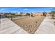 Community common area offers benches and walking paths amidst meticulous rock and grass landscaping at 5714 Sunset Sedona St # Lot 5, North Las Vegas, NV 89081