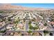 Expansive aerial view of a residential community nestled against a backdrop of majestic mountains on a clear, sunny day at 5772 Arbor Oak Cir, Las Vegas, NV 89142