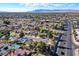 Wide aerial shot displays a dense neighborhood with pools and mountain views at 5772 Arbor Oak Cir, Las Vegas, NV 89142