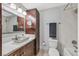 Nicely updated bathroom with wood cabinets, double sinks and a large mirror at 5772 Arbor Oak Cir, Las Vegas, NV 89142