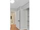 Bedroom featuring wood floors and a walk-in closet adjacent to an ensuite bathroom at 5772 Arbor Oak Cir, Las Vegas, NV 89142