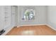Bright bedroom showcasing hardwood floors, white trim, and a large window with a courtyard view at 5772 Arbor Oak Cir, Las Vegas, NV 89142
