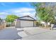 Single-Gathering home with a two-car garage and a concrete driveway with grass on the side at 5772 Arbor Oak Cir, Las Vegas, NV 89142
