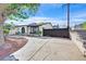 Charming home featuring an arched entryway, decorative stone, and a secure gated driveway at 5772 Arbor Oak Cir, Las Vegas, NV 89142