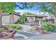 Beautiful single-story home with lush front yard landscaping and a quaint arched entryway at 5772 Arbor Oak Cir, Las Vegas, NV 89142