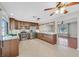 Modern kitchen with stainless steel appliances, granite countertops, tile flooring, and wood cabinetry at 5772 Arbor Oak Cir, Las Vegas, NV 89142