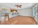 Bright living room featuring hardwood floors, a ceiling fan, and an open view to the kitchen at 5772 Arbor Oak Cir, Las Vegas, NV 89142
