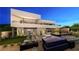 Modern two-story home features a sleek design with a balcony and desert landscaping, plus a luxurious backyard pool at 607 Grand Rim Dr, Henderson, NV 89012