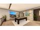 Modern game room with a pool table, stylish decor, and seamless access to an outdoor entertainment area at 607 Grand Rim Dr, Henderson, NV 89012