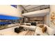 Open-concept living room featuring floor-to-ceiling windows with city views and modern furnishings at 607 Grand Rim Dr, Henderson, NV 89012