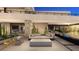 Beautiful outdoor living area with modern seating, fire feature, and seamless transition to interior spaces at 607 Grand Rim Dr, Henderson, NV 89012