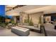 Inviting patio with a stone accent wall, modern outdoor seating, and seamless transition to indoor living spaces at 607 Grand Rim Dr, Henderson, NV 89012