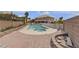 Wide backyard view showcasing a large pool with a spa and paved patio at 6116 Camas Canyon Ave, Las Vegas, NV 89130