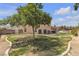 Spacious backyard featuring a mature tree, grass, and a patio area at 6116 Camas Canyon Ave, Las Vegas, NV 89130