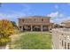 Large backyard with covered patio, lawn, and two story house at 6116 Camas Canyon Ave, Las Vegas, NV 89130