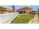 Large backyard with a white fence, grass, and a RV in the background at 6116 Camas Canyon Ave, Las Vegas, NV 89130