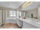 Bathroom featuring a soaking tub, glass enclosed shower, and double vanity at 6116 Camas Canyon Ave, Las Vegas, NV 89130