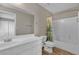 Bathroom featuring a large mirror, white cabinets, and a shower with a curtain, provides a clean aesthetic at 6116 Camas Canyon Ave, Las Vegas, NV 89130