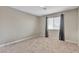 This bedroom features neutral walls, plush carpet, and a window with blinds for natural light at 6116 Camas Canyon Ave, Las Vegas, NV 89130