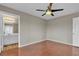 Bedroom includes hardwood floors, a fan, and a connecting door to the bathroom at 6116 Camas Canyon Ave, Las Vegas, NV 89130