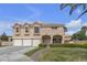 Inviting two-story home with a three-car garage and well-manicured lawn and desert landscaping at 6116 Camas Canyon Ave, Las Vegas, NV 89130