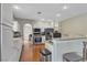 Bright kitchen featuring white cabinets, stainless appliances, bar seating, and open layout at 6116 Camas Canyon Ave, Las Vegas, NV 89130