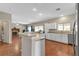 Kitchen with stainless steel appliances, ample counter space, and an open view to the living area and fireplace at 6116 Camas Canyon Ave, Las Vegas, NV 89130