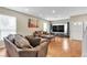 Comfortable living room features wood floors, neutral tones, large windows, and ample seating at 6116 Camas Canyon Ave, Las Vegas, NV 89130