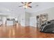 Bright open-concept with kitchen and living areas featuring hardwood floors and neutral walls at 6116 Camas Canyon Ave, Las Vegas, NV 89130