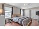 The main bedroom features wood floors, windows with curtains, and a double door closet at 6116 Camas Canyon Ave, Las Vegas, NV 89130