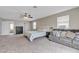 Spacious primary bedroom suite featuring plush carpet, a queen bed, and access to the ensuite bathroom at 6116 Camas Canyon Ave, Las Vegas, NV 89130