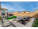 Beautiful backyard with an inviting patio, manicured artificial lawn, and a relaxing hot tub area at 6544 Sandero Springs St, Las Vegas, NV 89166