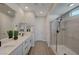 Bathroom featuring double sinks with light-colored countertops and modern fixtures plus a glass shower at 6544 Sandero Springs St, Las Vegas, NV 89166