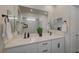 Bathroom with a double sink vanity with bright countertops and modern matte black fixtures at 6544 Sandero Springs St, Las Vegas, NV 89166