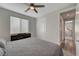 Bright bedroom features a ceiling fan, window and connects to the ensuite bathroom at 6544 Sandero Springs St, Las Vegas, NV 89166