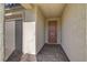 Inviting covered entryway with brick-paved flooring leading to a wood front door and a two-car garage at 6544 Sandero Springs St, Las Vegas, NV 89166