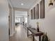 Bright hallway with wood-look tile floors, stylish wall decor, and views into other rooms at 6544 Sandero Springs St, Las Vegas, NV 89166