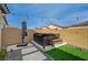 Private outdoor hot tub area with manicured artificial turf, stone pavers, and lush landscaping for relaxing at 6544 Sandero Springs St, Las Vegas, NV 89166