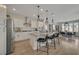 Well-lit kitchen featuring white cabinetry, stainless steel appliances, pendant lighting and a center island with bar seating at 6544 Sandero Springs St, Las Vegas, NV 89166