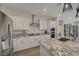Beautiful kitchen with modern appliances, granite countertops, spacious island, and stylish pendant lighting at 6544 Sandero Springs St, Las Vegas, NV 89166