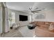 Bright living room with a large leather couch, modern decor, and a view of the outdoor patio at 6544 Sandero Springs St, Las Vegas, NV 89166