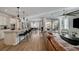 Open concept living space with a kitchen island, dining area, and a comfortable living room setup at 6544 Sandero Springs St, Las Vegas, NV 89166