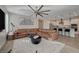 Open concept living area with a spacious leather couch, adjacent to the kitchen and dining area at 6544 Sandero Springs St, Las Vegas, NV 89166