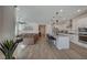 Open-concept living area with spacious kitchen, cozy leather couch, contemporary decor, and wood-look tile flooring at 6544 Sandero Springs St, Las Vegas, NV 89166