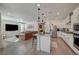 Bright, open-concept kitchen and living room featuring modern appliances, sleek countertops, and cozy furnishings at 6544 Sandero Springs St, Las Vegas, NV 89166