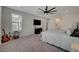 Another view of the main bedroom featuring a ceiling fan, window with shutters, and modern décor at 6544 Sandero Springs St, Las Vegas, NV 89166