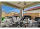 Covered outdoor patio with stylish seating and fire pit feature at 6544 Sandero Springs St, Las Vegas, NV 89166